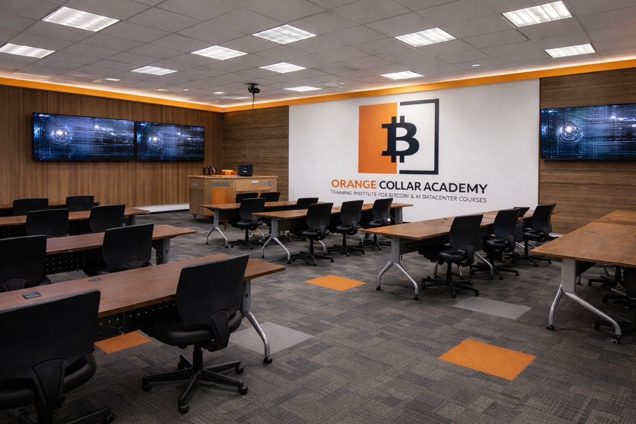 OCA training classroom with branded wall and workstations