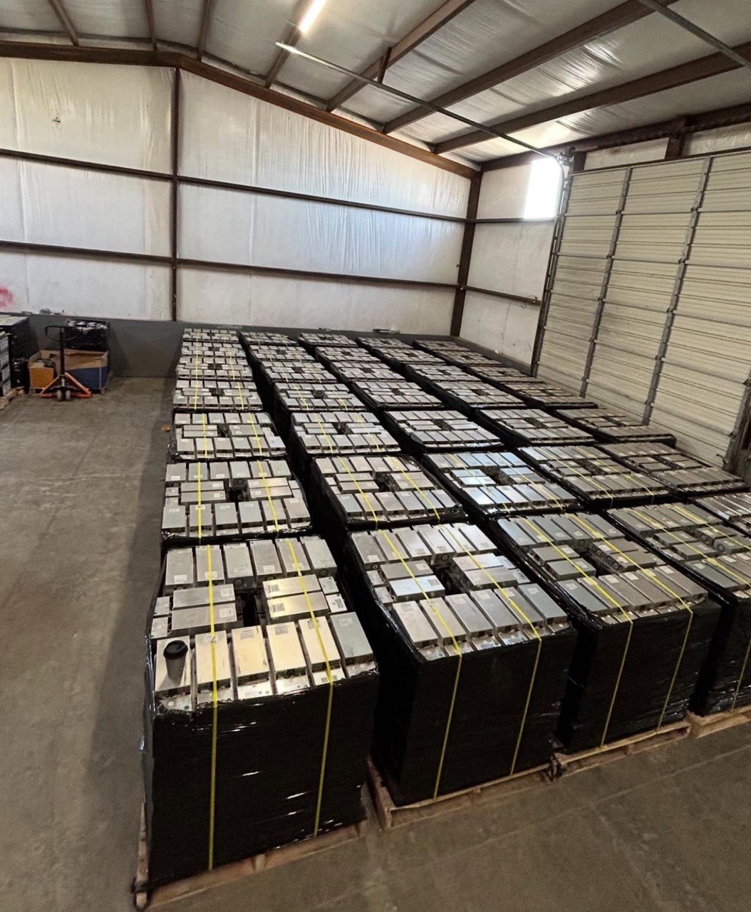 OCA warehouse floor — densely packed mining hardware on pallets